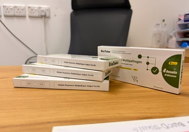 BioTeke multiple respiratory multipathogen antigen test kit boxes on a wooden desk.