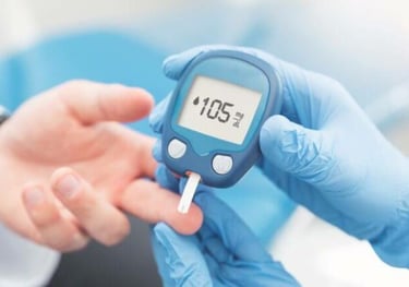 A healthcare professional in blue gloves uses a digital glucose meter to test a patient's blood sugar levels.