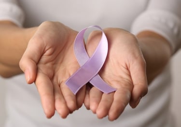 a person holding a purple ribbon with a purple ribbon