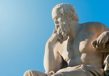 a statue of a man sitting on a bench