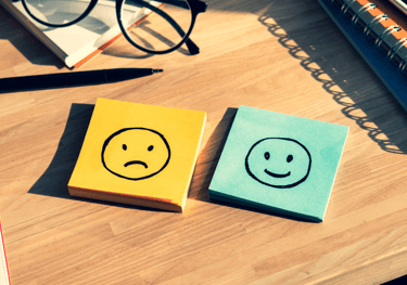 a note pad with a smiley face drawn on it
