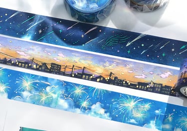 A collection of decorative washi tapes featuring starry night sky, city sunset, and firework designs.