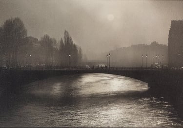 Atmospheric black and white photography of a foggy bridge over the Seine River in Paris.