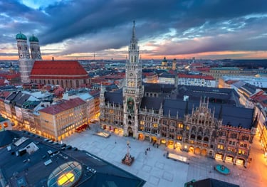 Panoramic sunset view of Marienplatz with the New Town Hall and Frauenkirche in Munich, Germany.