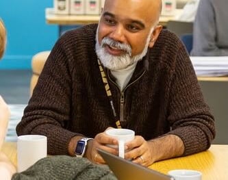 Avi Sinharay chatting holding a cup of tea