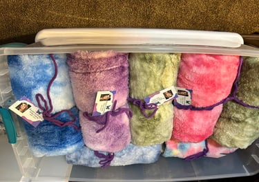 Colorful blankets in a clear tub