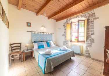 a bed room with a bed and a chair