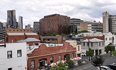 Picture of Faraday Street Carlton, with University of Melbourne buildings in the distance on the right