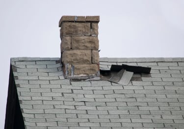 a chimney with a cap on top of a brick house