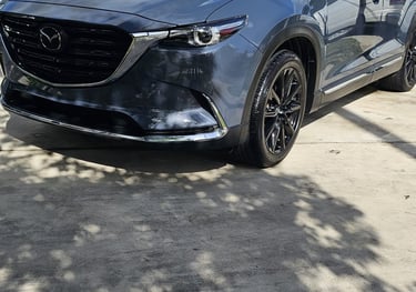 a mazda suv parked in front of a house
