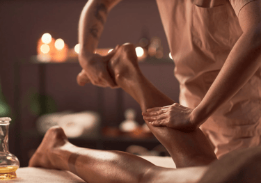 A person getting their calf massaged.