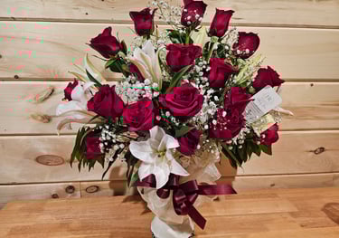 a bouquet of red roses in a vase on a table