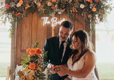 a bride and groom cutting their wedding cake