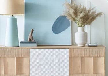 a picture of a dresser with a vase of flowers