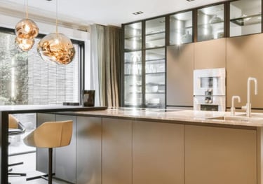 a kitchen with a large island and a bar stool