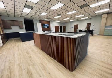 a kitchen island with a counter top and a bar top