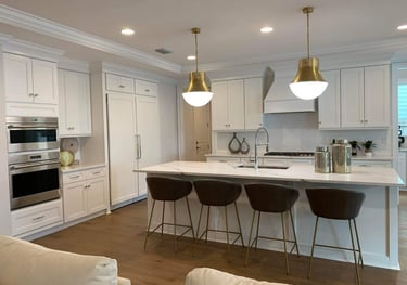 a kitchen with a large island and a bar stool