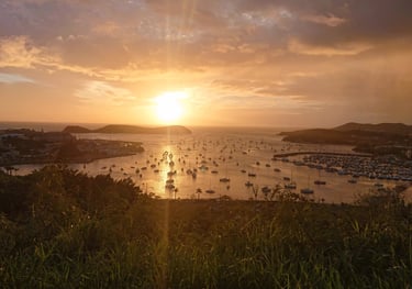 a sunset over a body of water with boats