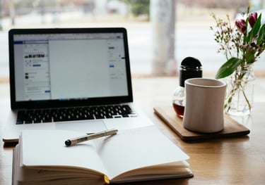 Photo of a desk with a laptop and mug