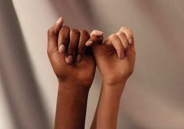 Photo of two hands linking their little fingers