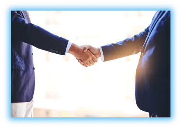 Two business men shaking hands with the sun shining in the background