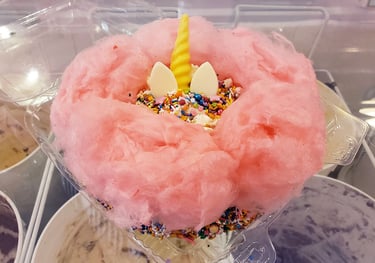 Ice cream cake with cotton candy and unicorn topping