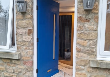 an open blue door with a dust sheet on the ground