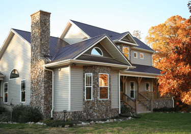 a house with a stone chimney and a chimney