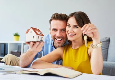 a man and woman holding keys to a house