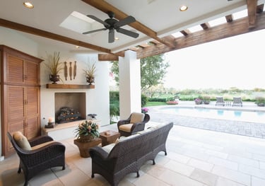 a patio with wicker furniture and a fireplace