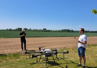 standing in a field with a remote and a drone