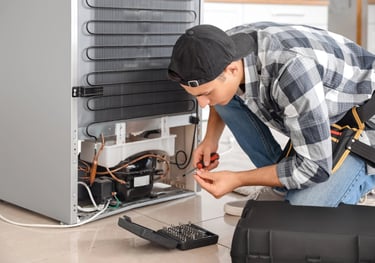 a person repairing a fridge