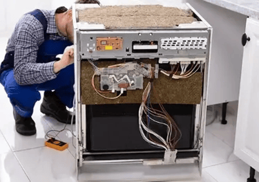 a technician repairing a dishwasher front panel is removed