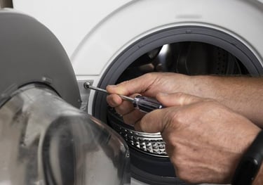 person tightening the door screw of a washer