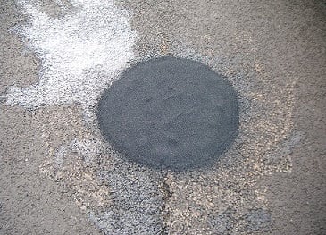 a pothole doctor heat repair on a road 