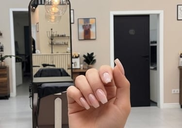 a person showing her BIAB nails done in Nacre Nails Newport