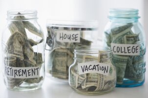 Four glass jars (different sizes and shape) labeled 'Retirement', 'House', 'Vacation' and 'College'.