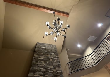 a chandelier in a high foyer