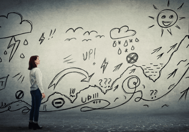 a woman standing in front of a wall with a drawing showing the path of personal transformation
