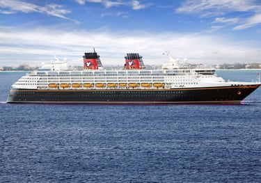 A gargantuan Disney Cruise ship, with a red, yellow, and black color scheme evoking Mickey Mouse