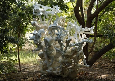 Paper and concrete based sculpture in forest garden.