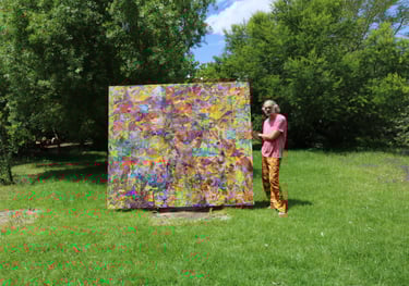 Artist standing with large oil painting on Belgian linen in garden 