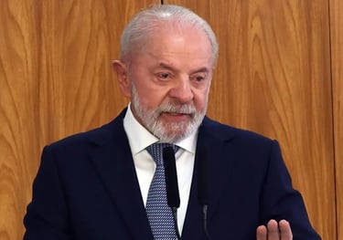 a man in a suit and tie is speaking into a microphone