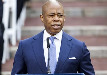 a man in a suit and tie standing in front of a podium