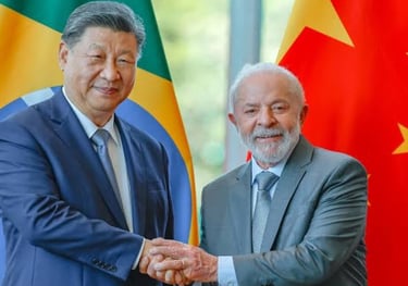 a man in a suit and tie standing next to a flag