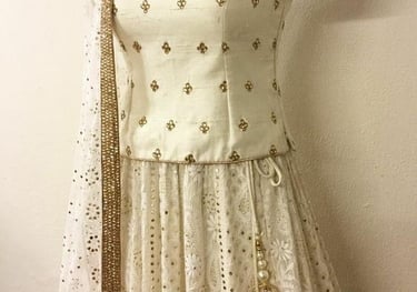 a white and gold colored dress with a white and gold dress