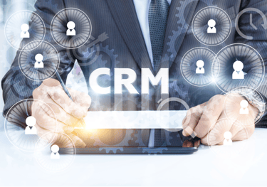 a man in a suit and tie is holding a tablet with a crm on