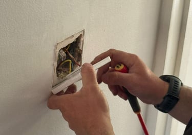 Electrician fixing a light switch in Norwich