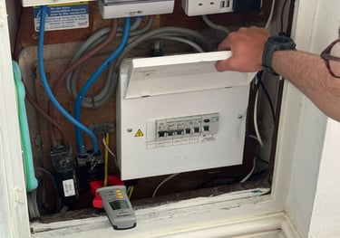 Electrician inspecting fuse board in Norwich