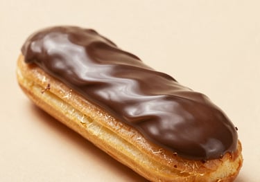 Close-up of a chocolate eclair with glossy ganache, artistic presentation on a beige background, Western European pastry shop style.